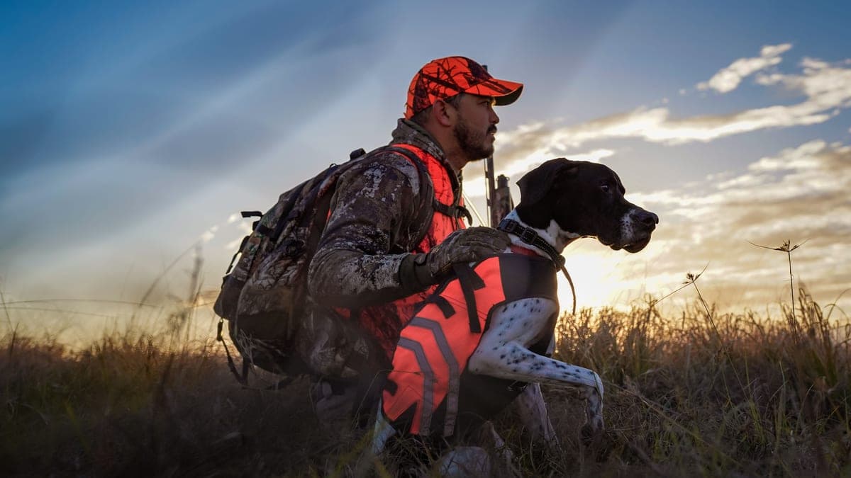New hunter checking gear in warm morning light